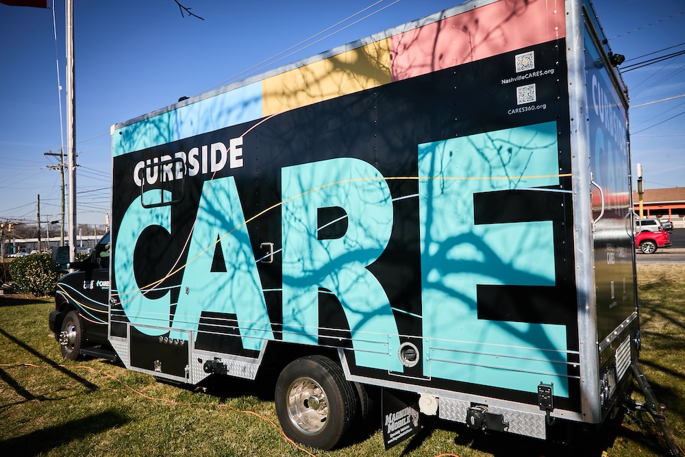 CARES 360 mobile health clinic serving community members at outdoor event.
